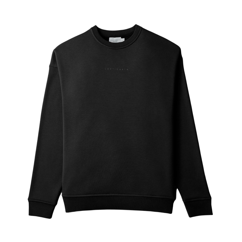 A person with curly hair models the Cozy Earth Women's CityScape Crewneck and matching pants in light pink against a plain white backdrop. |Color:Peony