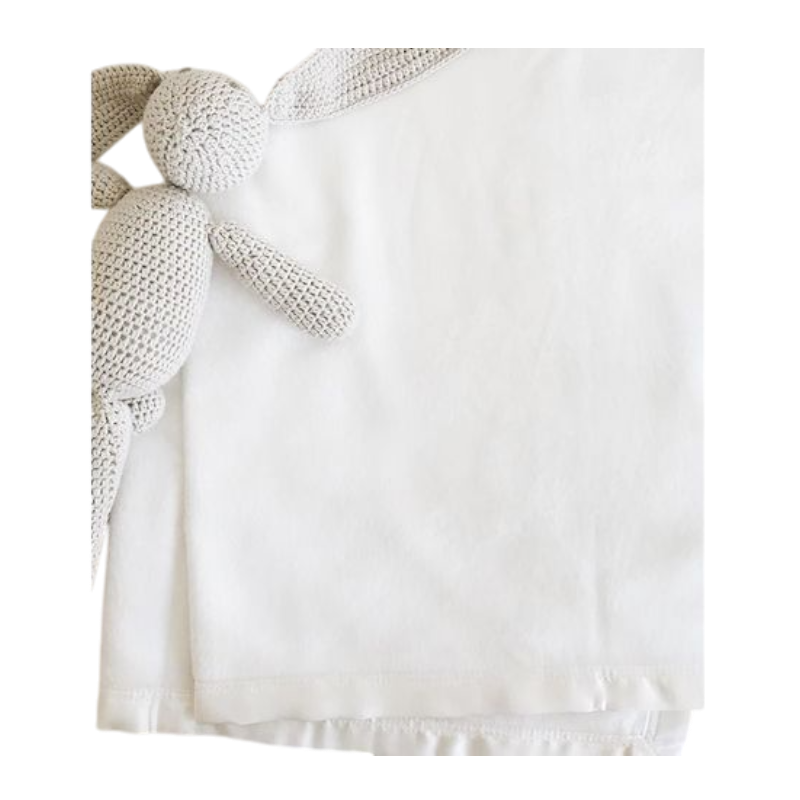 White baby blanket with knitted stuffed bunny