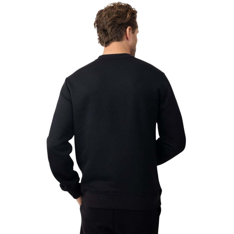 A man with short brown hair is wearing a dark green Men's CityScape Crewneck from Cozy Earth, featuring the words "COLD EARTH" printed on it. He is gazing slightly to the side against a plain white background. |Color:Spruce