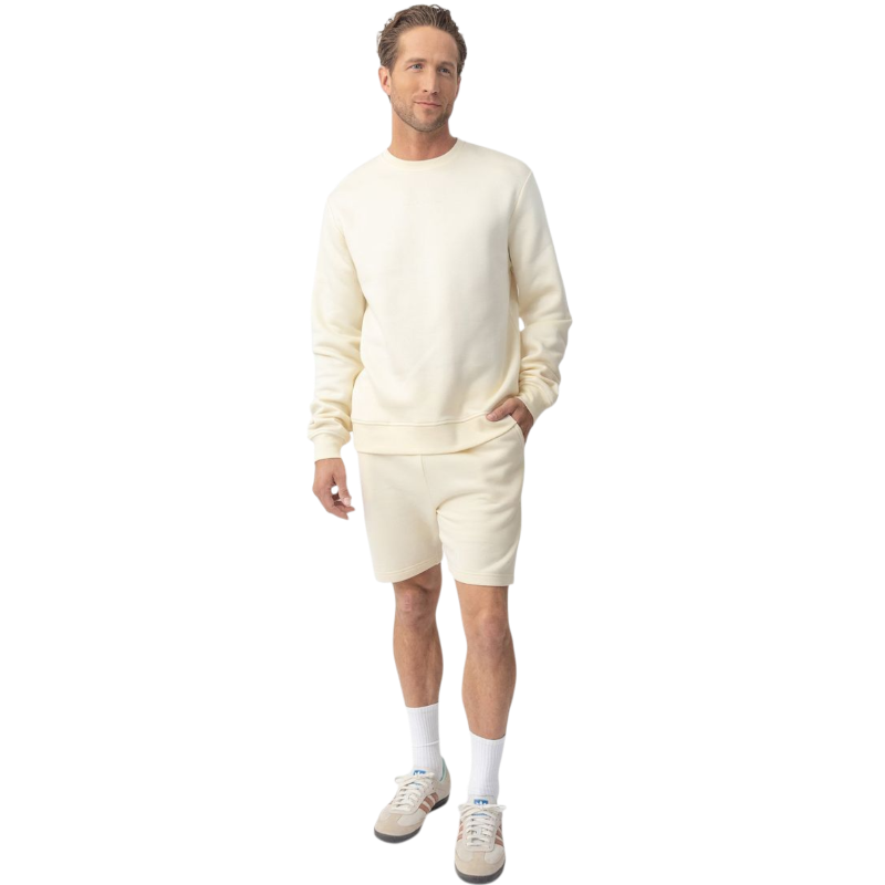 A man with short brown hair is wearing a dark green Men's CityScape Crewneck from Cozy Earth, featuring the words "COLD EARTH" printed on it. He is gazing slightly to the side against a plain white background. |Color:Spruce