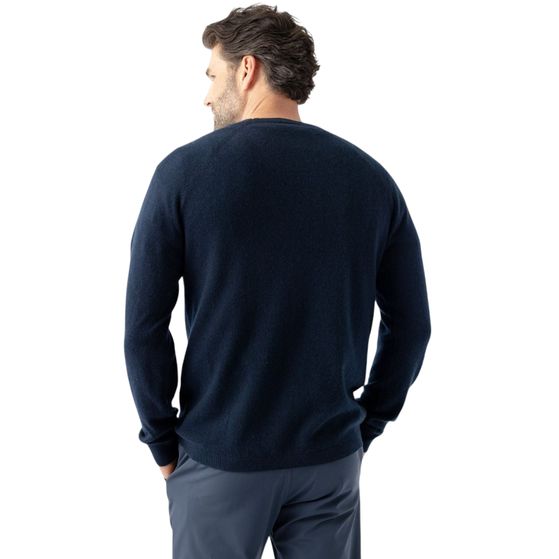 A man with dark hair and a beard stands casually with his hands in his pockets. He is wearing the Cozy Earth Men's Crewneck Sweater in navy blue, paired with gray pants. He looks at the camera with a neutral expression, set against a plain white background. |Color:Eclipse