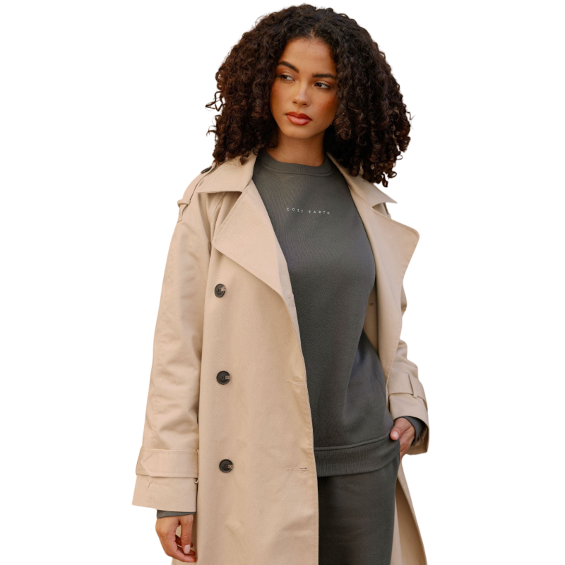 A person with curly hair models the Cozy Earth Women's CityScape Crewneck and matching pants in light pink against a plain white backdrop. |Color:Peony