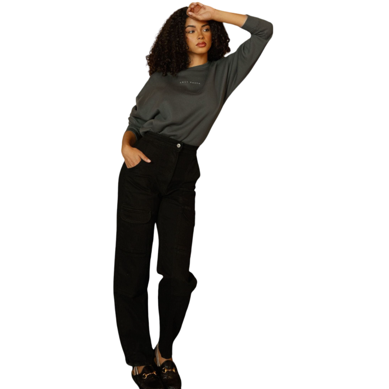 A person with curly hair models the Cozy Earth Women's CityScape Crewneck and matching pants in light pink against a plain white backdrop. |Color:Peony