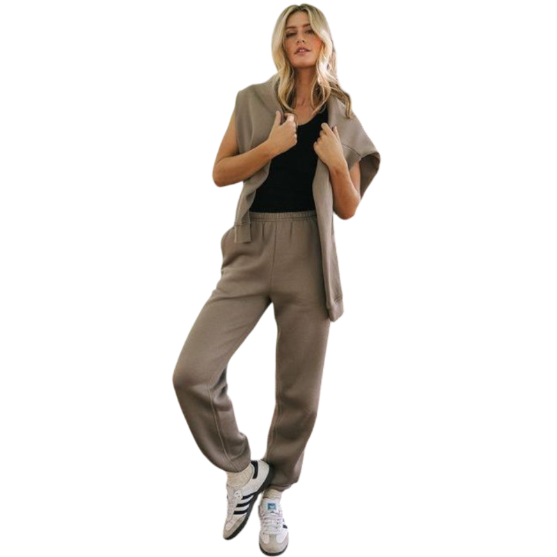 A person with curly hair models the Cozy Earth Women's CityScape Crewneck and matching pants in light pink against a plain white backdrop. |Color:Peony
