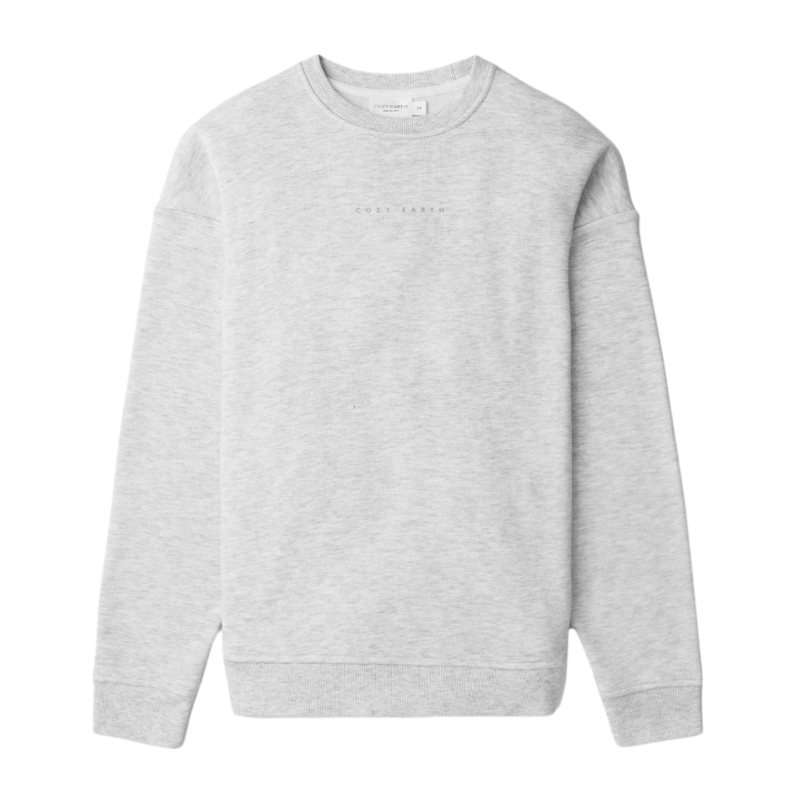 A person with curly hair models the Cozy Earth Women's CityScape Crewneck and matching pants in light pink against a plain white backdrop. |Color:Peony