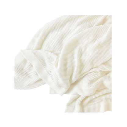 Ivory Cloud Knit Baby Blanket draped over crib |Color:Ivory