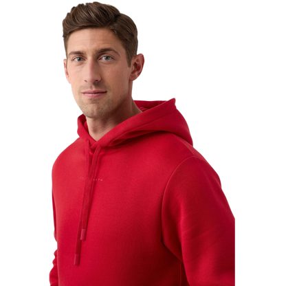 A person wearing a vibrant Men's CityScape Hoodie from Cozy Earth stands against a plain white background. They have short brown hair and are looking directly at the camera with a neutral expression. |Color:Crimson