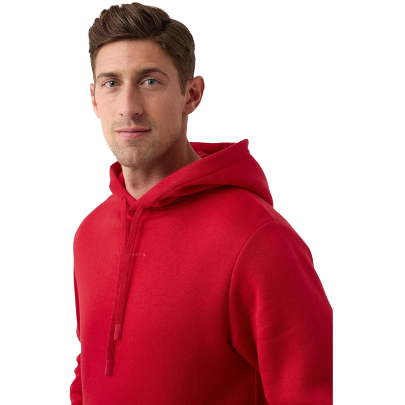 A person wearing a vibrant Men's CityScape Hoodie from Cozy Earth stands against a plain white background. They have short brown hair and are looking directly at the camera with a neutral expression. |Color:Crimson