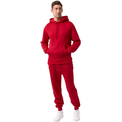 A person with curly hair is wearing a Cozy Earth Men's CityScape Hoodie in dark green and standing against a plain white background, with their hands together. |Color:Spruce