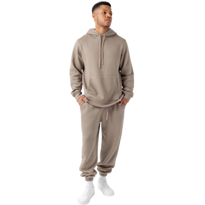 A person with curly hair is wearing a Cozy Earth Men's CityScape Hoodie in dark green and standing against a plain white background, with their hands together. |Color:Spruce