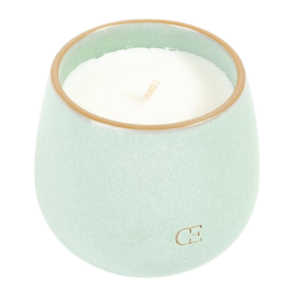 A young child with long blonde hair smiles while wearing a navy blue Kid's CityScape Hoodie by Cozy Earth and matching pants. She has two hair ties, one pink and one blue. The background is plain white. |Color:Eclipse