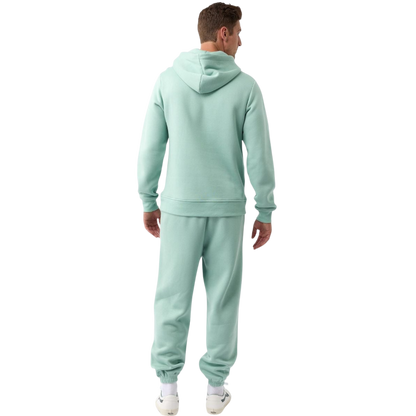 A person with curly hair is wearing a Cozy Earth Men's CityScape Hoodie in dark green and standing against a plain white background, with their hands together. |Color:Spruce