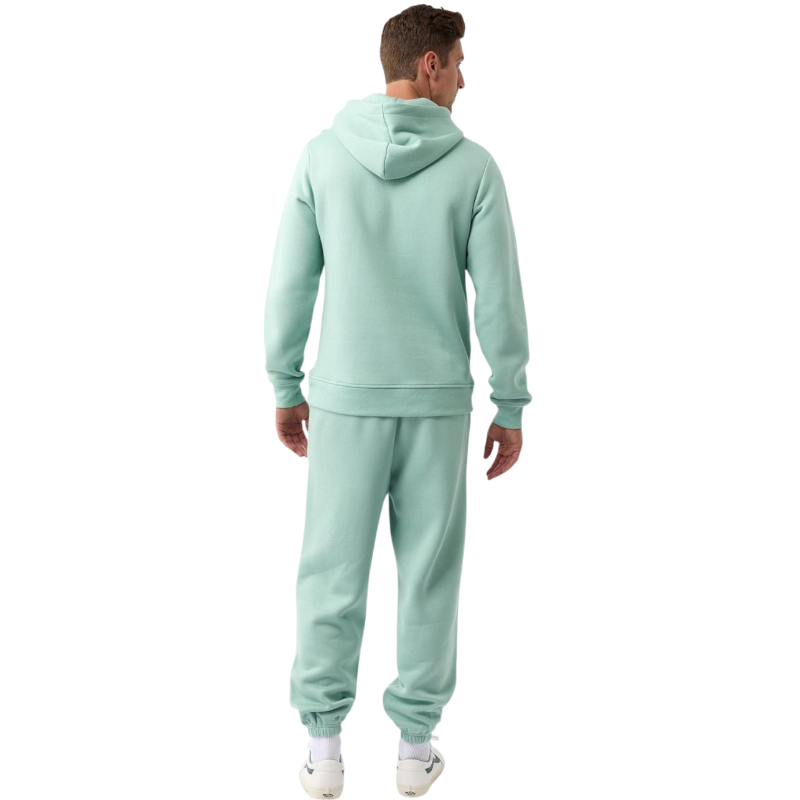 A person with curly hair is wearing a Cozy Earth Men's CityScape Hoodie in dark green and standing against a plain white background, with their hands together. |Color:Spruce