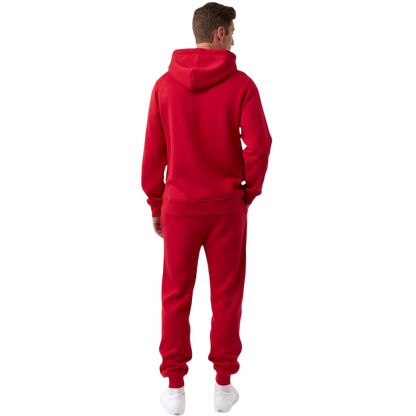 A person with curly hair is wearing a Cozy Earth Men's CityScape Hoodie in dark green and standing against a plain white background, with their hands together. |Color:Spruce