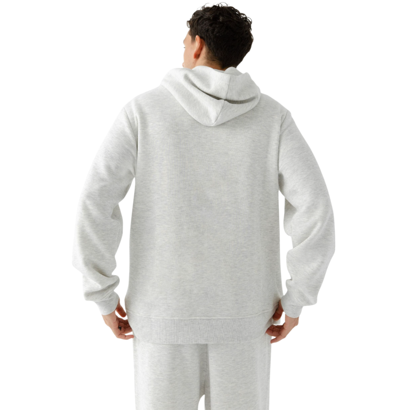 A person with curly hair is wearing a Cozy Earth Men's CityScape Hoodie in dark green and standing against a plain white background, with their hands together. |Color:Spruce
