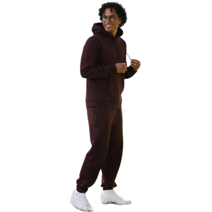 A person with curly hair is wearing a Cozy Earth Men's CityScape Hoodie in dark green and standing against a plain white background, with their hands together. |Color:Spruce