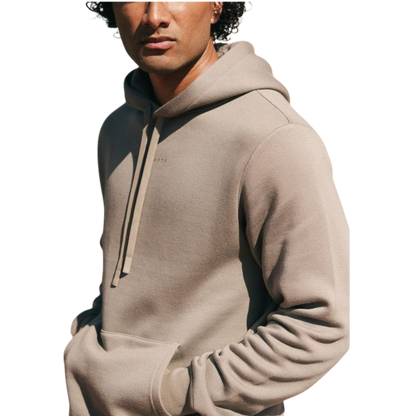 A person with curly hair is wearing a Cozy Earth Men's CityScape Hoodie in dark green and standing against a plain white background, with their hands together. |Color:Spruce