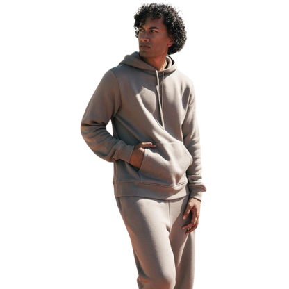 A person with curly hair is wearing a Cozy Earth Men's CityScape Hoodie in dark green and standing against a plain white background, with their hands together. |Color:Spruce