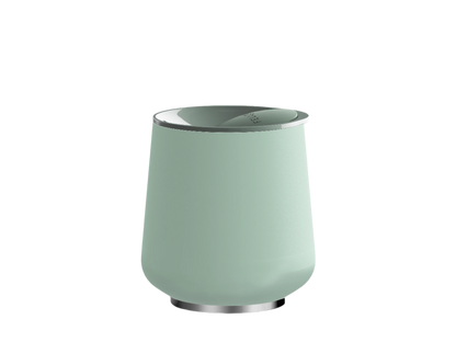 The Ruby Wine Tumbler by Fellow is sleek and light green with a glossy silver rim and base. Its insulated body features True Taste ceramic coating, ensuring your drink stays perfect against a plain background.