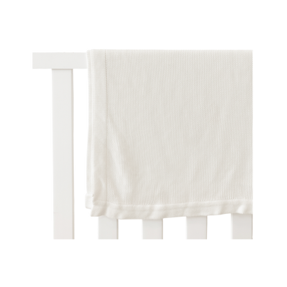 White Cloud Knit Baby Blanket draped over white crib |Color:White