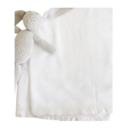 White baby blanket with knitted stuffed bunny