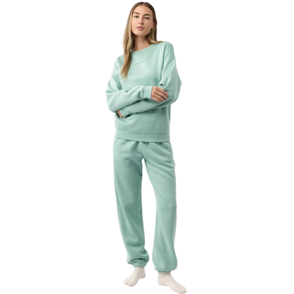 A young boy with blond hair is wearing the Cozy Earth Kid's CityScape Crewneck sweatshirt along with matching pants. He is standing, smiling, and looking slightly to the side against a plain white background. |Color:Eclipse