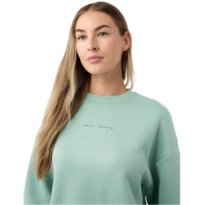 A young boy with blond hair is wearing the Cozy Earth Kid's CityScape Crewneck sweatshirt along with matching pants. He is standing, smiling, and looking slightly to the side against a plain white background. |Color:Eclipse