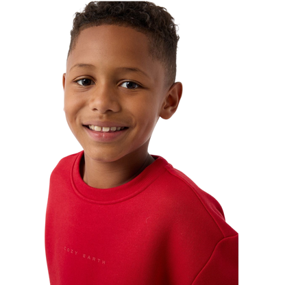 A young boy with blond hair is wearing the Cozy Earth Kid's CityScape Crewneck sweatshirt along with matching pants. He is standing, smiling, and looking slightly to the side against a plain white background. |Color:Eclipse