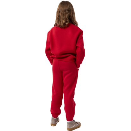 A young boy with blond hair is wearing the Cozy Earth Kid's CityScape Crewneck sweatshirt along with matching pants. He is standing, smiling, and looking slightly to the side against a plain white background. |Color:Eclipse