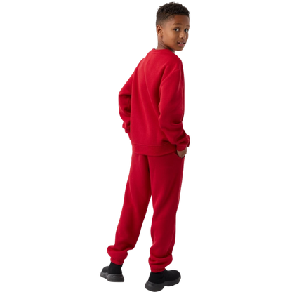 A young boy with blond hair is wearing the Cozy Earth Kid's CityScape Crewneck sweatshirt along with matching pants. He is standing, smiling, and looking slightly to the side against a plain white background. |Color:Eclipse