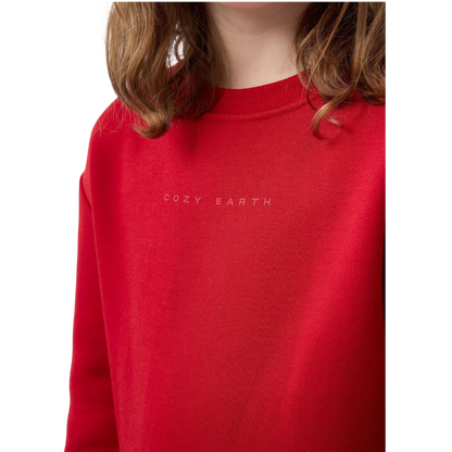 A young boy with blond hair is wearing the Cozy Earth Kid's CityScape Crewneck sweatshirt along with matching pants. He is standing, smiling, and looking slightly to the side against a plain white background. |Color:Eclipse