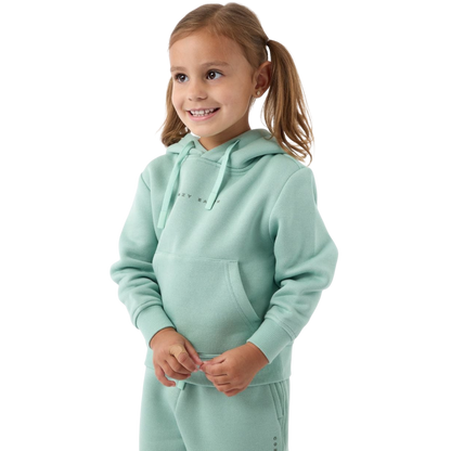 A young girl with light brown hair in pigtails smiles while wearing a mint green Kid's CityScape Hoodie and matching pants from Cozy Earth. She stands against a plain white background. |Color:Wintergreen