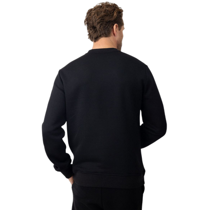 A man with short brown hair is wearing a dark green Men's CityScape Crewneck from Cozy Earth, featuring the words "COLD EARTH" printed on it. He is gazing slightly to the side against a plain white background. |Color:Spruce