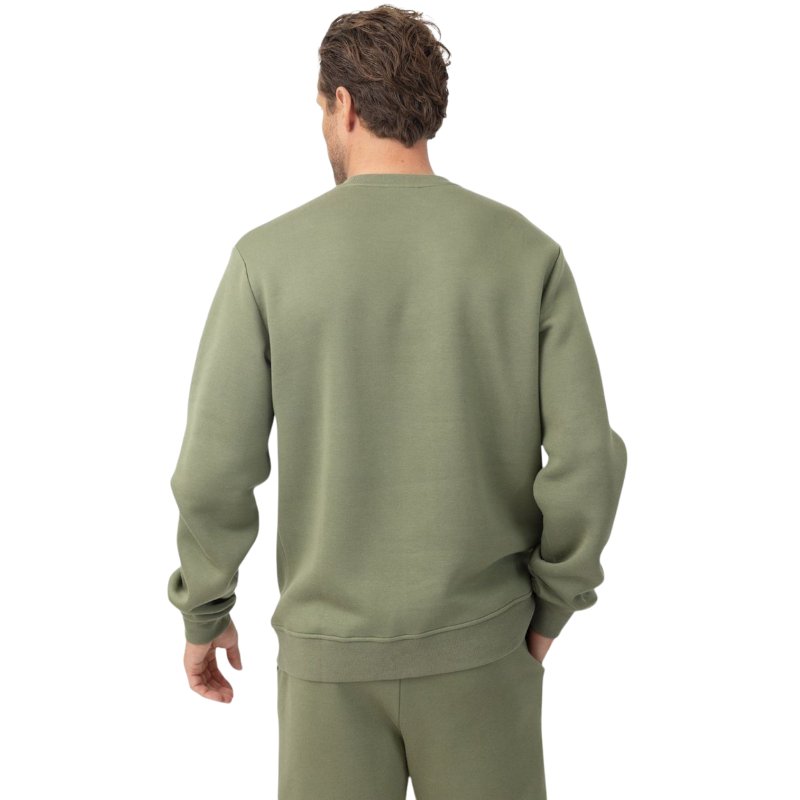 A man with short brown hair is wearing a dark green Men's CityScape Crewneck from Cozy Earth, featuring the words "COLD EARTH" printed on it. He is gazing slightly to the side against a plain white background. |Color:Spruce