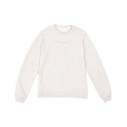 A man with short brown hair is wearing a dark green Men's CityScape Crewneck from Cozy Earth, featuring the words "COLD EARTH" printed on it. He is gazing slightly to the side against a plain white background. |Color:Spruce