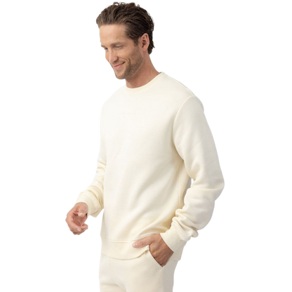 A man with short brown hair is wearing a dark green Men's CityScape Crewneck from Cozy Earth, featuring the words "COLD EARTH" printed on it. He is gazing slightly to the side against a plain white background. |Color:Spruce