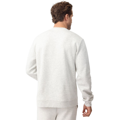 A man with short brown hair is wearing a dark green Men's CityScape Crewneck from Cozy Earth, featuring the words "COLD EARTH" printed on it. He is gazing slightly to the side against a plain white background. |Color:Spruce
