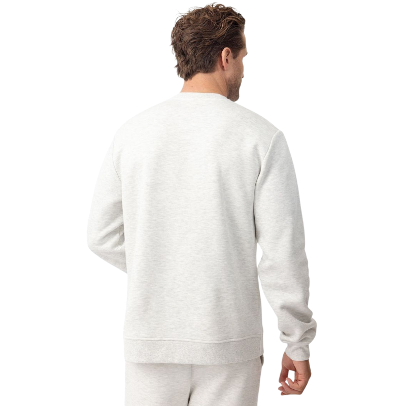 A man with short brown hair is wearing a dark green Men's CityScape Crewneck from Cozy Earth, featuring the words "COLD EARTH" printed on it. He is gazing slightly to the side against a plain white background. |Color:Spruce