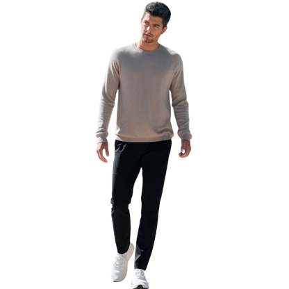 A man with dark hair and a beard stands casually with his hands in his pockets. He is wearing the Cozy Earth Men's Crewneck Sweater in navy blue, paired with gray pants. He looks at the camera with a neutral expression, set against a plain white background. |Color:Eclipse