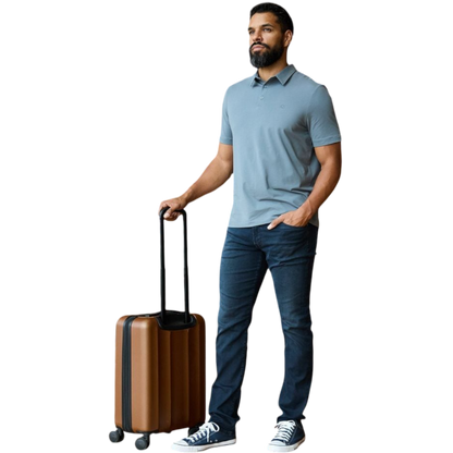 A person with short, light brown hair is wearing the Men's Everyday Polo by Cozy Earth in a light gray shade, paired with light beige pants. They are standing and slightly looking over their left shoulder with a neutral expression against a plain white background. |Color:Stone