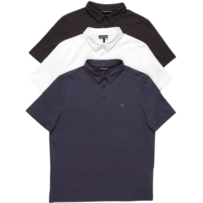 A person with short, light brown hair is wearing the Men's Everyday Polo by Cozy Earth in a light gray shade, paired with light beige pants. They are standing and slightly looking over their left shoulder with a neutral expression against a plain white background. |Color:Stone