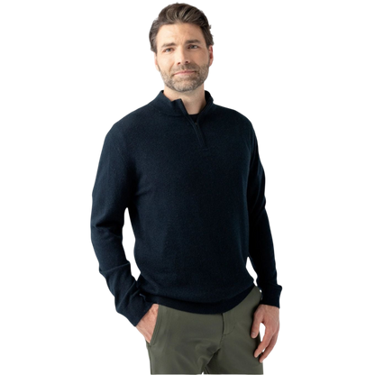 A man with short, dark hair and a beard is standing against a plain white background. He is wearing a Men's Quarter Zip Sweater by Cozy Earth, which is dark and long-sleeved, paired with olive-green pants. His hands are in his pockets, and he has a neutral expression on his face. |Color:Jet Black