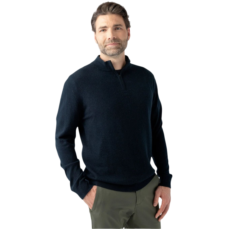 A man with short, dark hair and a beard is standing against a plain white background. He is wearing a Men's Quarter Zip Sweater by Cozy Earth, which is dark and long-sleeved, paired with olive-green pants. His hands are in his pockets, and he has a neutral expression on his face. |Color:Jet Black