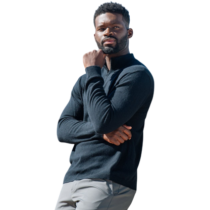 A man with dark hair and a short beard is wearing a navy blue Men's Quarter Zip Sweater from Cozy Earth paired with beige pants. He stands with his hands in his pockets against a plain white background, looking to his right with a slight smile. |Color:Eclipse