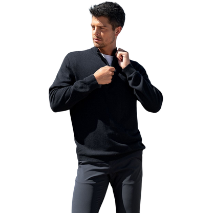 A man with dark hair and a short beard is wearing a navy blue Men's Quarter Zip Sweater from Cozy Earth paired with beige pants. He stands with his hands in his pockets against a plain white background, looking to his right with a slight smile. |Color:Eclipse