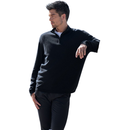 A man with dark hair and a short beard is wearing a navy blue Men's Quarter Zip Sweater from Cozy Earth paired with beige pants. He stands with his hands in his pockets against a plain white background, looking to his right with a slight smile. |Color:Eclipse