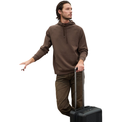 A person wearing the Men's StretchTech Hoodie from Cozy Earth, paired with matching gray pants, stands against a plain white background. The hoodie features drawstrings and a front pocket. The individual is looking forward with a neutral expression. |Color:Coal Heather