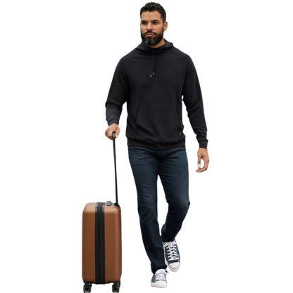 A person wearing the Men's StretchTech Hoodie from Cozy Earth, paired with matching gray pants, stands against a plain white background. The hoodie features drawstrings and a front pocket. The individual is looking forward with a neutral expression. |Color:Coal Heather