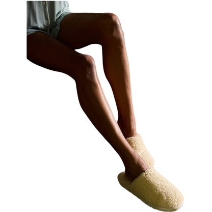 A pair of Puffy Sheep Slippers by Cozy Earth, featuring a cozy tan design with a fuzzy, textured exterior and soft interior, crafted in a slip-on style with rubber soles, set against a plain white background. |Color:Fawn