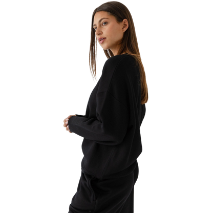 Black CityScape Pullover Crew. The Pullover is being worn by a female model. Accompanying city scape clothing is being worn to complete the look of the outfit. The photo was taken with a white background. |Color:Black
